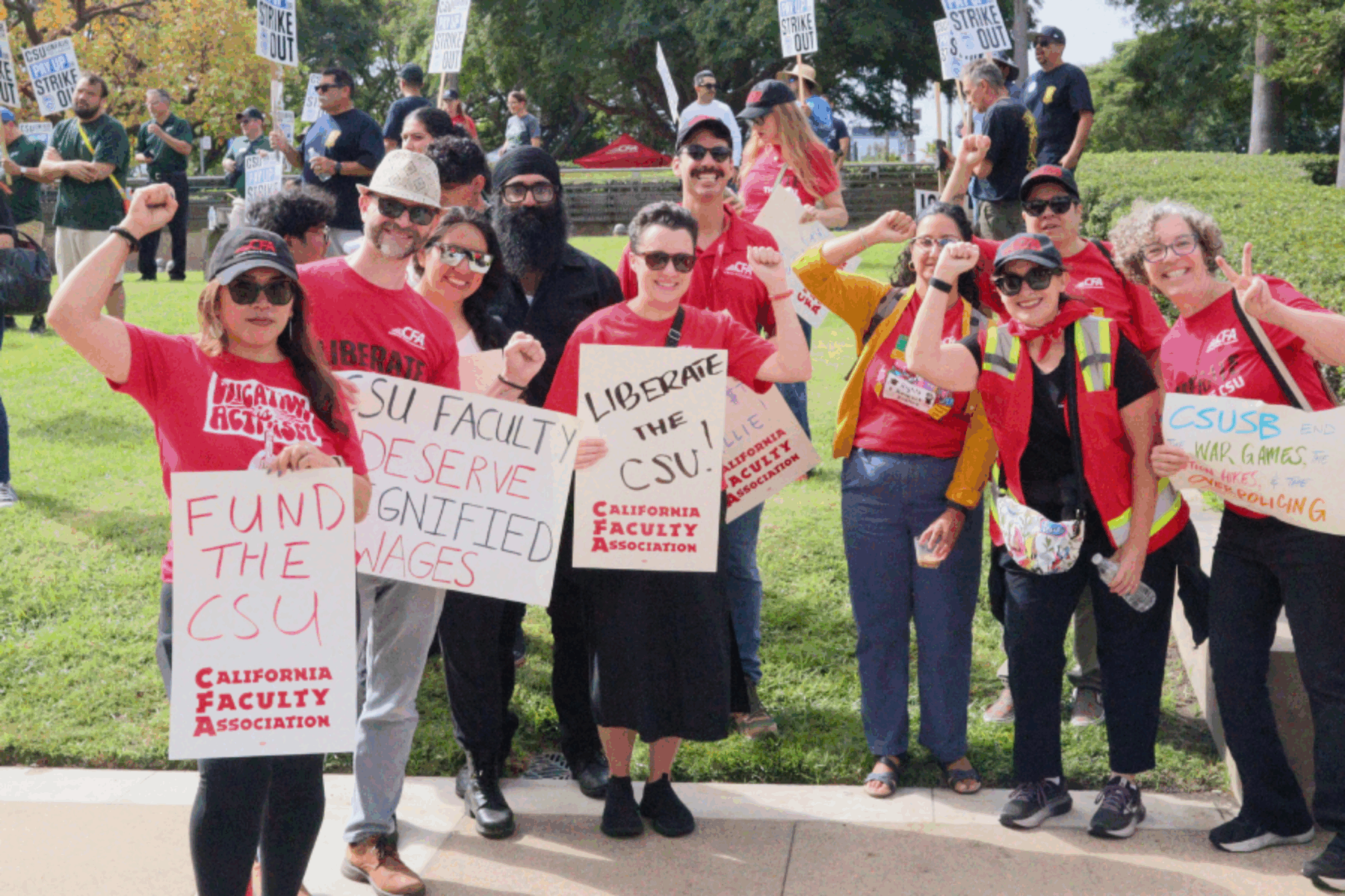 A group of people outdoors with a sign