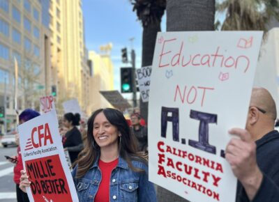 Two people holding signs