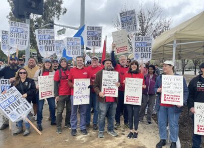 Groups of people outdoors holding signs at in support of the Teamsters strike.