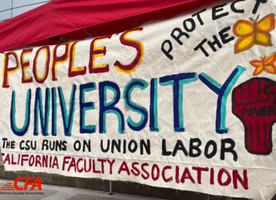 A banner hand painted that reads People's University