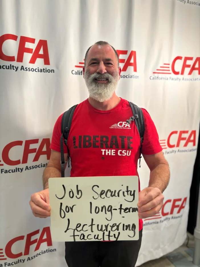 A person in red shirt with a sign