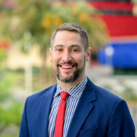 candidate in blue suit and red tie