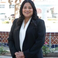 candidate with black suit jacket and white blouse