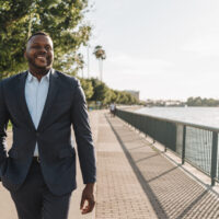 candidate walking with hand in pocket