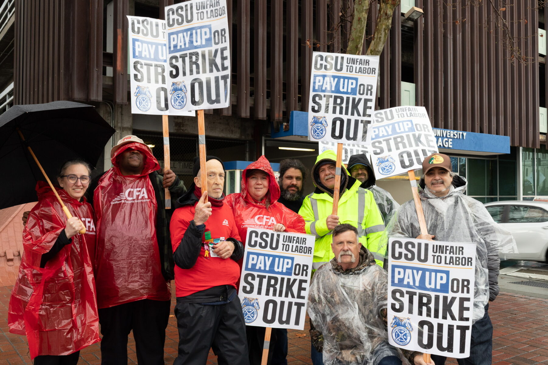 CFA members on the picket line with Teamsters, Smiling for a picture.