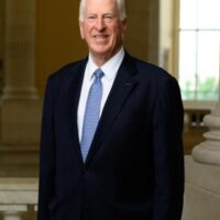 candidate in black suit and blue tie