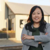 candidate with arms crossed in grey jacket