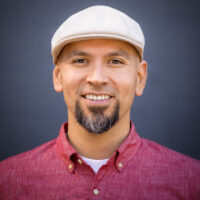 member in tan hat and red button up shirt
