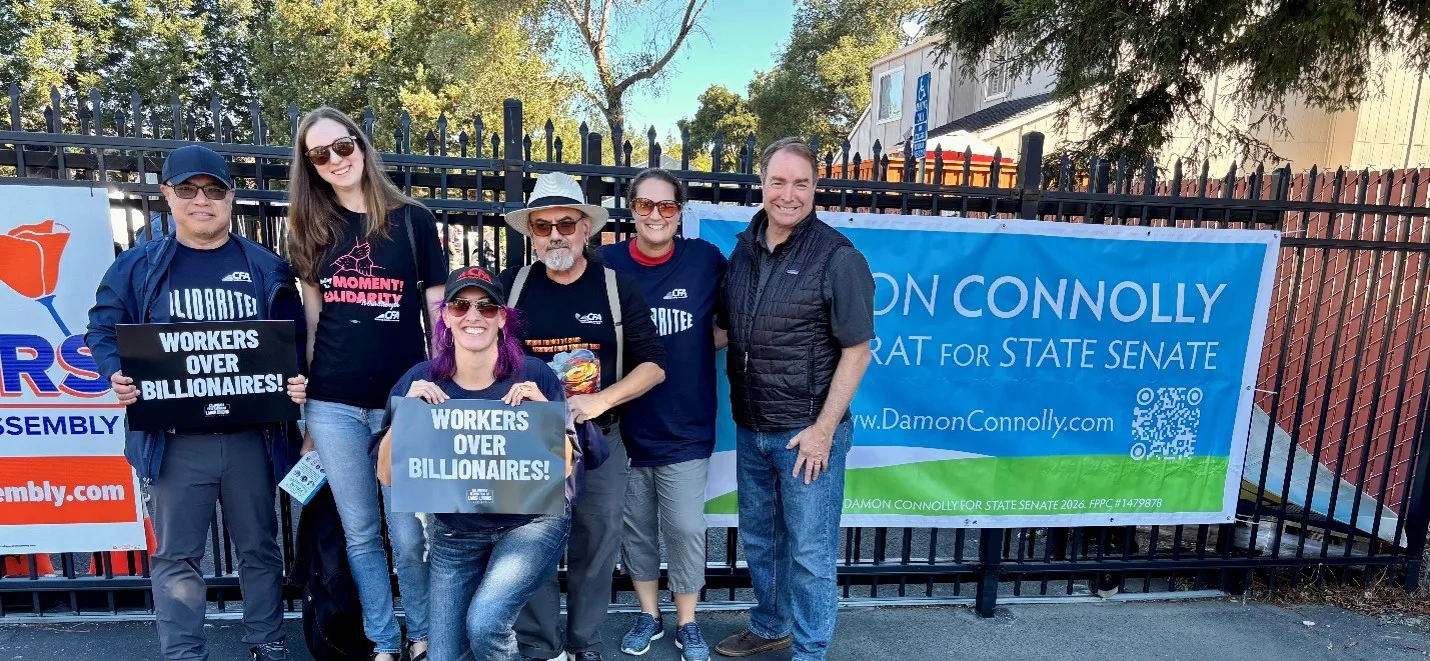 A group of CFA members taking a photo with an assemblymember.